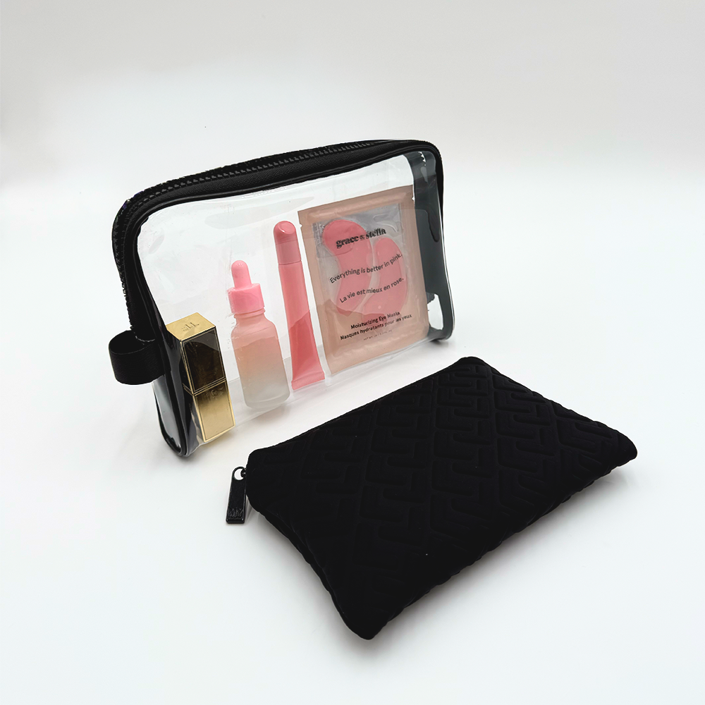 Black makeup bag with cosmetic items on a white background