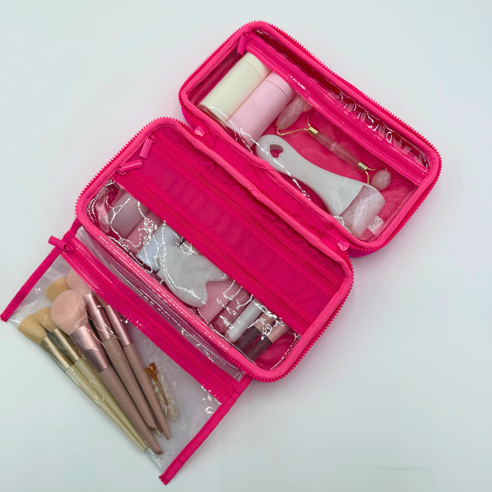 Pink makeup case with brushes and tools on a light background